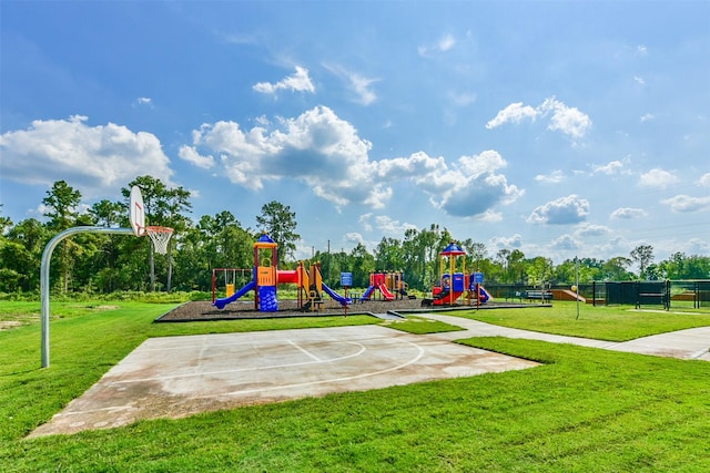 view of playground with basketball court and a yard