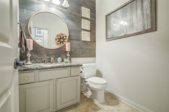 bathroom featuring vanity, toilet, and tile patterned flooring