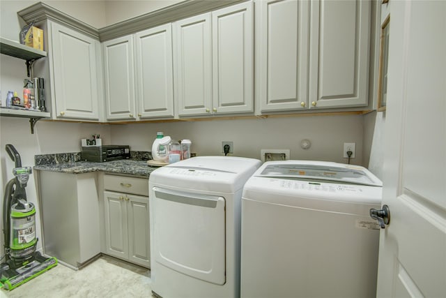 laundry room featuring cabinets and washer and dryer