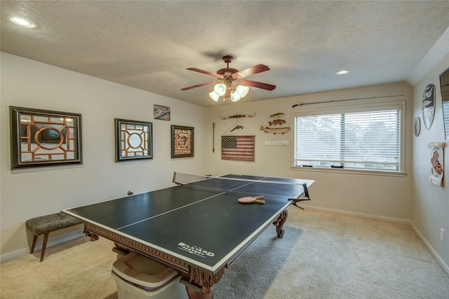 rec room featuring ceiling fan, light carpet, and a textured ceiling