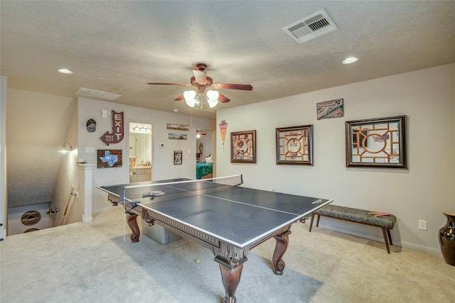 game room featuring ceiling fan, carpet floors, and a textured ceiling