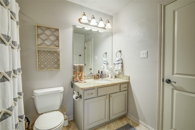 bathroom with vanity, tile patterned floors, and toilet