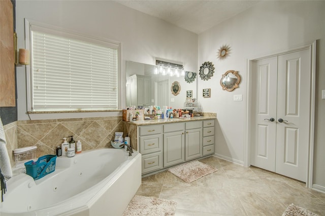 bathroom with vanity and a bath