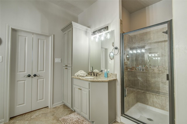 bathroom with vanity, an enclosed shower, and tile patterned flooring