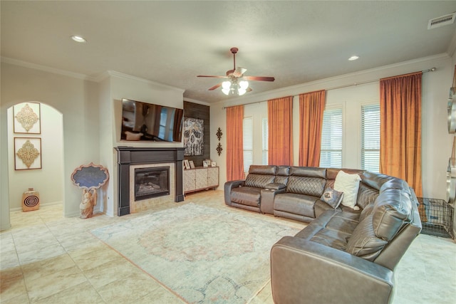 living room with crown molding and ceiling fan