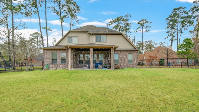 rear view of house with a lawn and a patio area