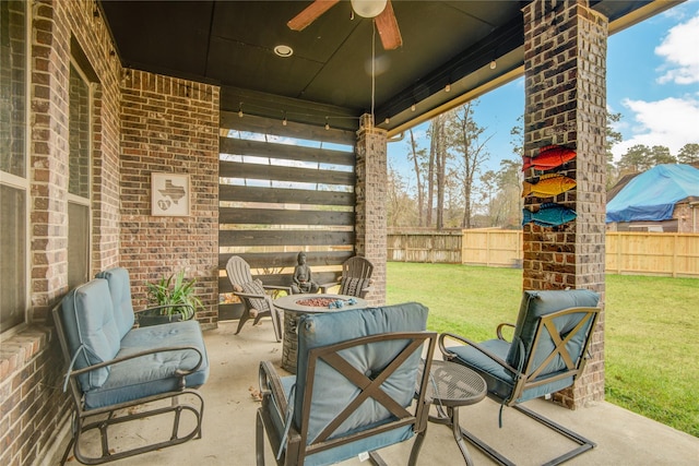 view of patio / terrace featuring ceiling fan and a fire pit