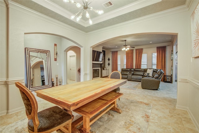 dining room with crown molding, a raised ceiling, and a notable chandelier