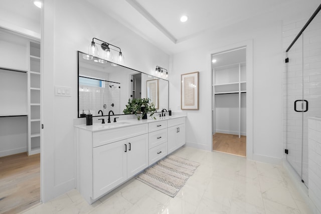 bathroom with vanity and a shower with shower door