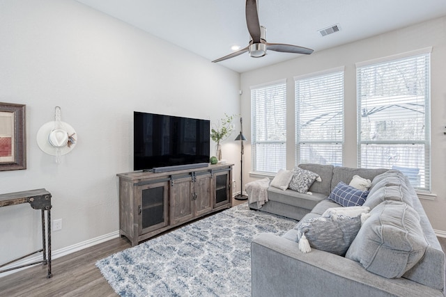 living room with ceiling fan, hardwood / wood-style flooring, and a healthy amount of sunlight