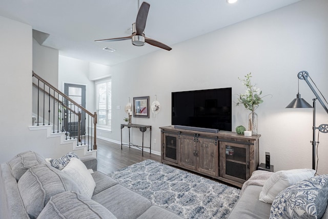 living room with ceiling fan and dark hardwood / wood-style flooring