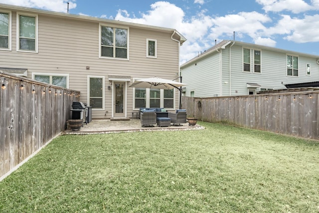 rear view of property with outdoor lounge area, a yard, and a patio area