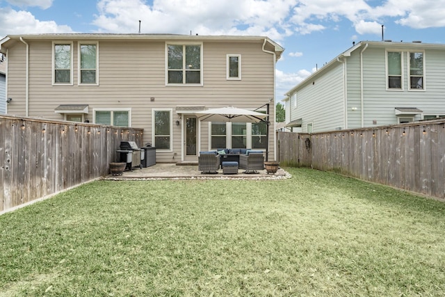 back of house with an outdoor living space, a patio area, and a lawn