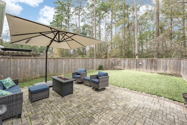 view of patio / terrace with an outdoor living space with a fire pit