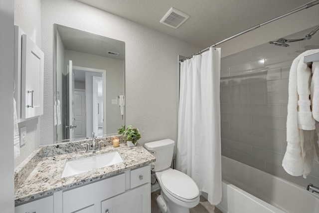 full bathroom featuring vanity, shower / tub combo, a textured ceiling, and toilet