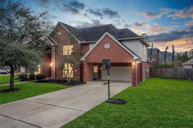 front of property with a garage and a yard