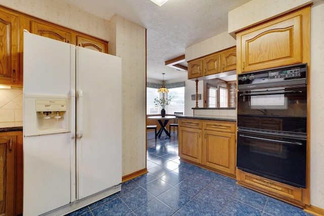 kitchen with double oven, decorative light fixtures, tasteful backsplash, white refrigerator with ice dispenser, and a textured ceiling