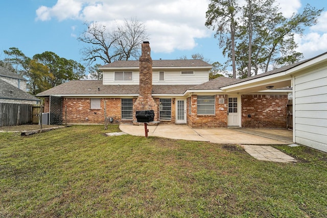 rear view of house with a lawn, central air condition unit, and a patio area