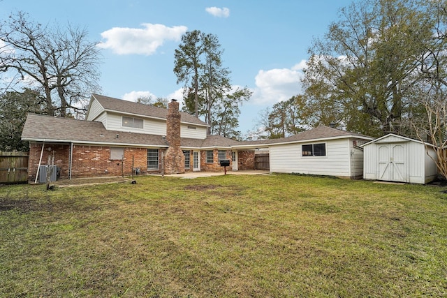 back of property featuring a shed, a yard, and a patio