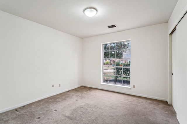 unfurnished bedroom featuring carpet flooring and a closet