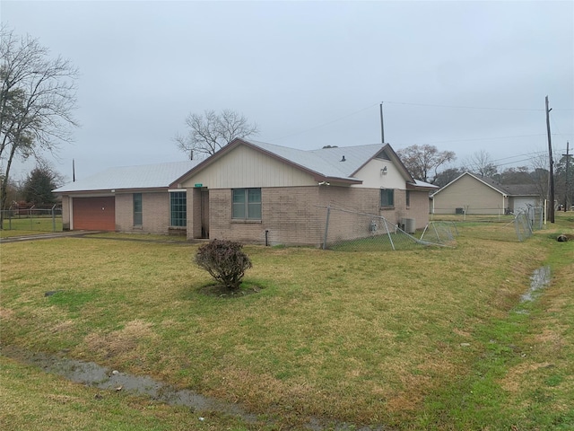 back of property with a yard and a garage