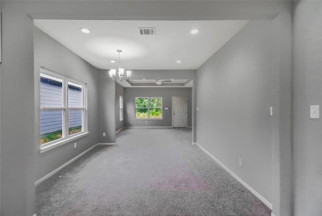 unfurnished room with carpet floors and an inviting chandelier