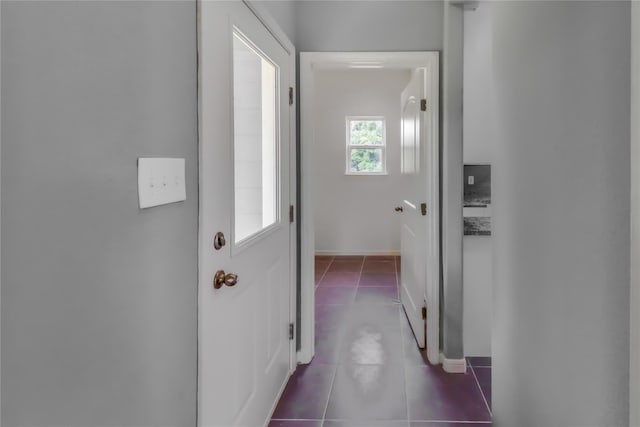 hallway with dark tile patterned floors