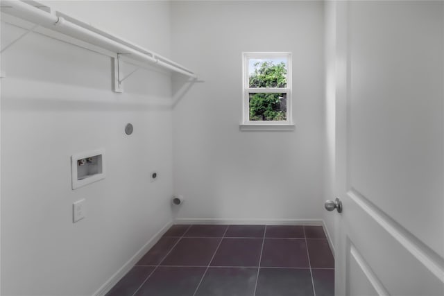 washroom featuring hookup for an electric dryer, hookup for a washing machine, and dark tile patterned floors