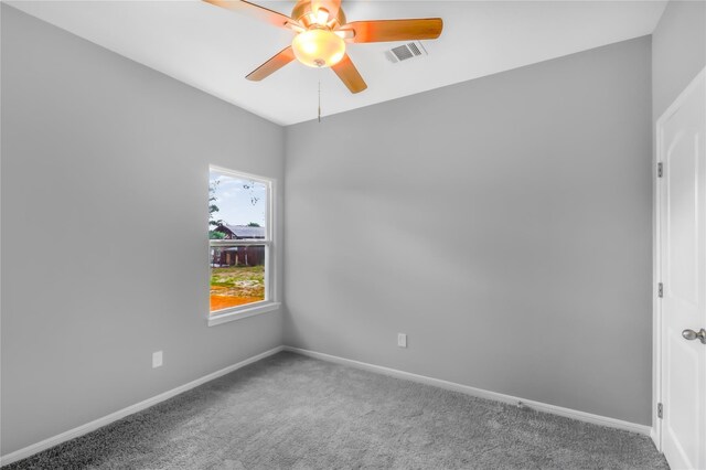 spare room with ceiling fan and carpet