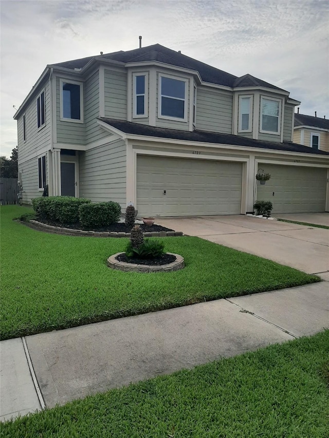 view of front of property featuring a garage and a front yard