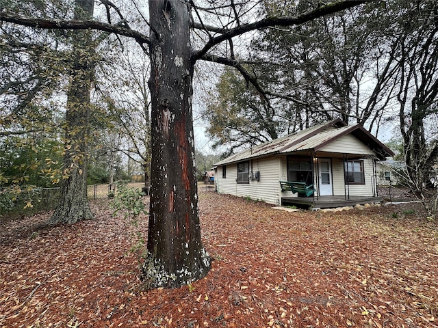 view of side of property with covered porch