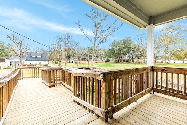 wooden deck featuring a yard