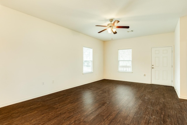 empty room with dark hardwood / wood-style floors and ceiling fan