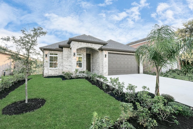 view of front of home with a garage and a front lawn