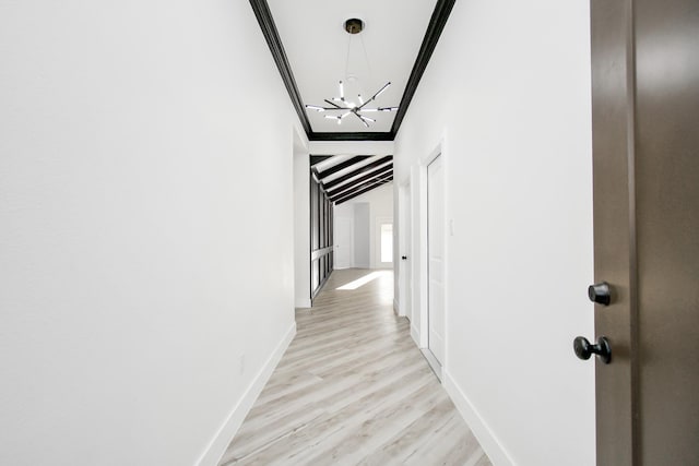 corridor with ornamental molding, light wood-type flooring, and vaulted ceiling with beams