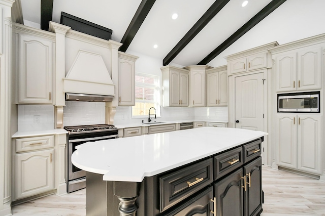 kitchen featuring a kitchen island, vaulted ceiling with beams, decorative backsplash, stainless steel appliances, and custom range hood