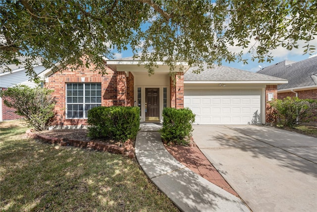 ranch-style home featuring brick siding, a shingled roof, concrete driveway, a front yard, and a garage