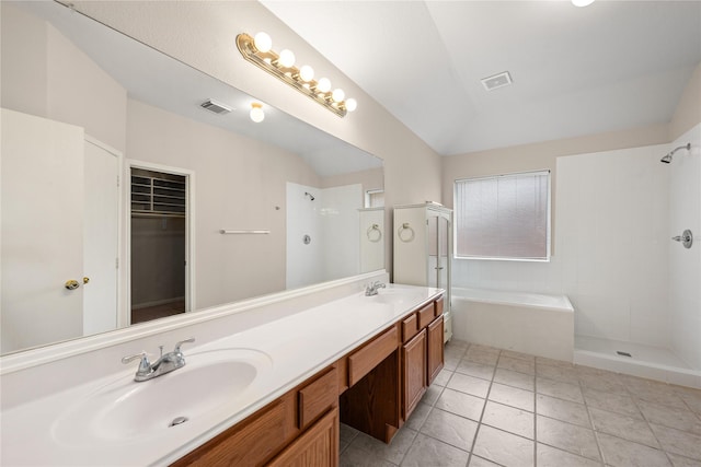 bathroom with lofted ceiling, a sink, visible vents, tiled shower, and a bath