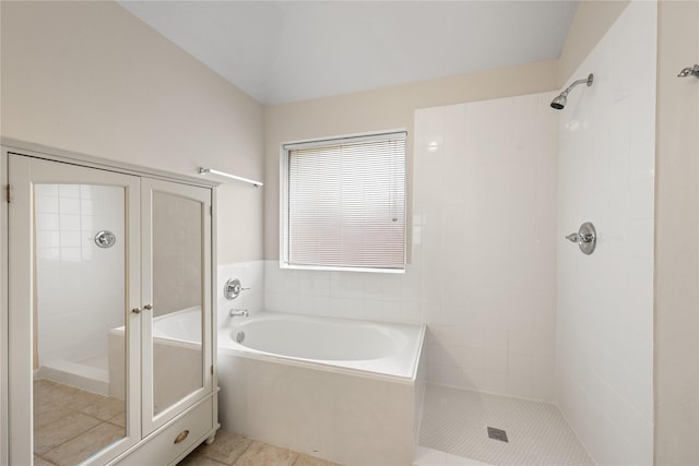 full bathroom with a stall shower, tile patterned flooring, and a bath