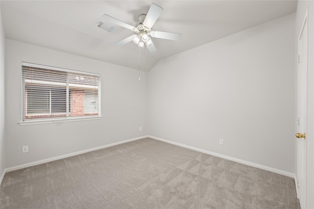 unfurnished room with lofted ceiling, light colored carpet, a ceiling fan, baseboards, and visible vents