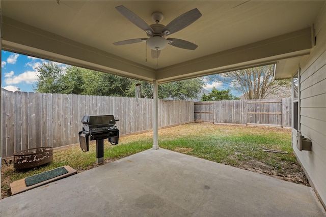 view of patio / terrace with area for grilling, a fenced backyard, and a ceiling fan