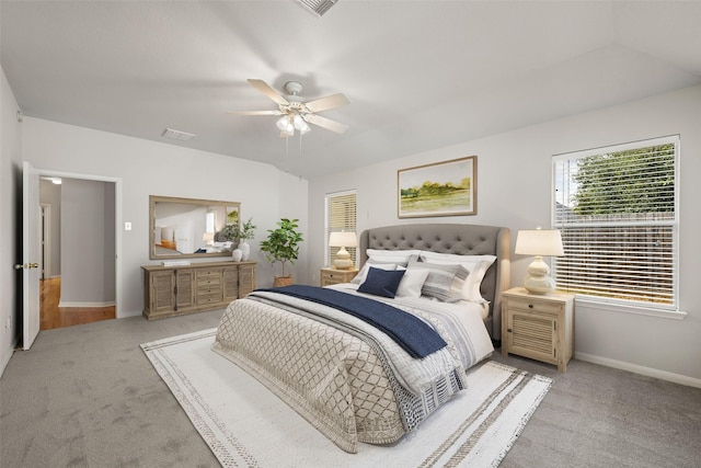 bedroom featuring baseboards, ceiling fan, visible vents, and light colored carpet