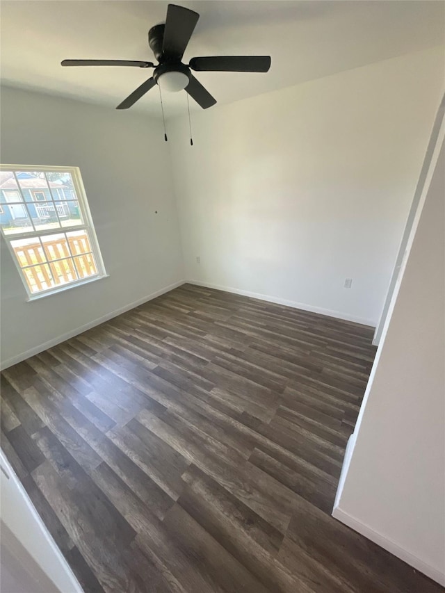 empty room with dark wood-type flooring and ceiling fan