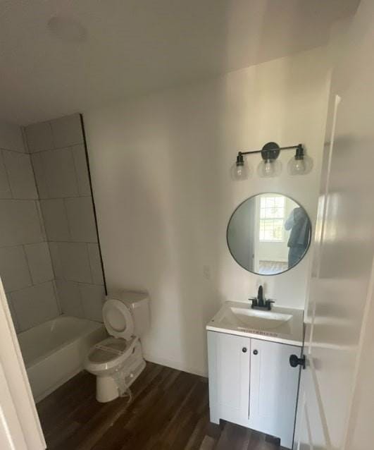 full bathroom with vanity, hardwood / wood-style flooring, shower / tub combination, and toilet