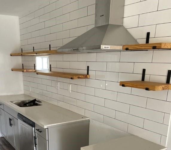 kitchen with tasteful backsplash, stainless steel dishwasher, sink, and extractor fan