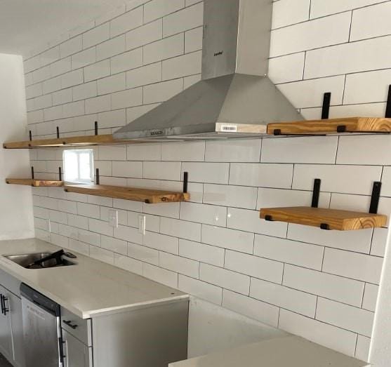 kitchen with tasteful backsplash, sink, ventilation hood, and dishwasher