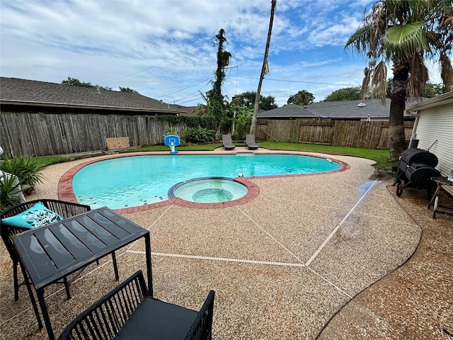 view of swimming pool featuring a patio and an in ground hot tub