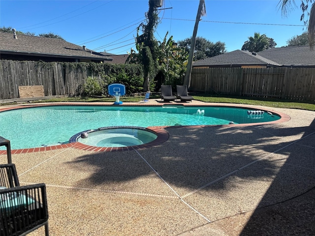 view of swimming pool with an in ground hot tub