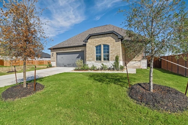 view of front of home featuring a garage and a front lawn