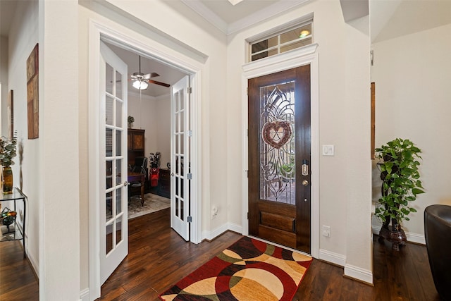 entrance foyer with dark hardwood / wood-style flooring, ornamental molding, and french doors